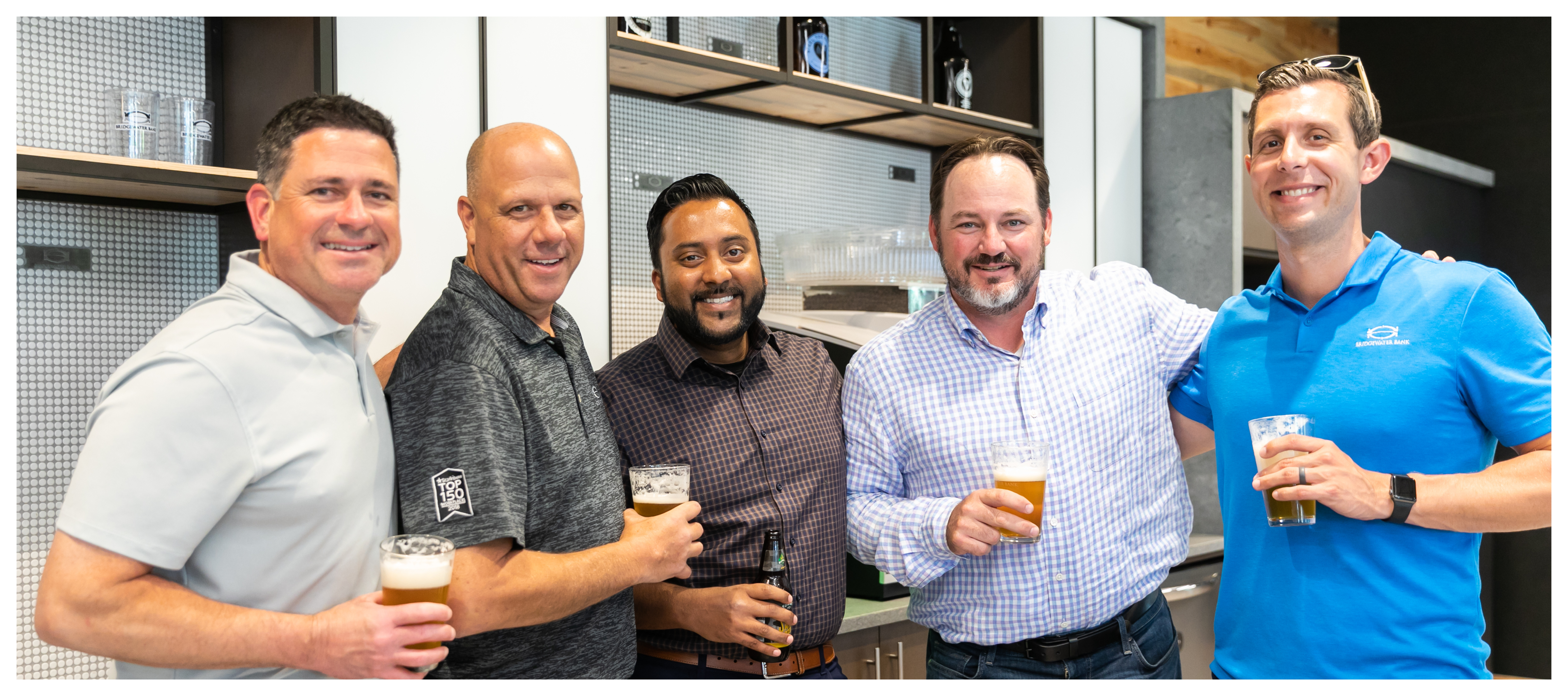 Group photo of MB Investment Group team members at an internal happy hour.